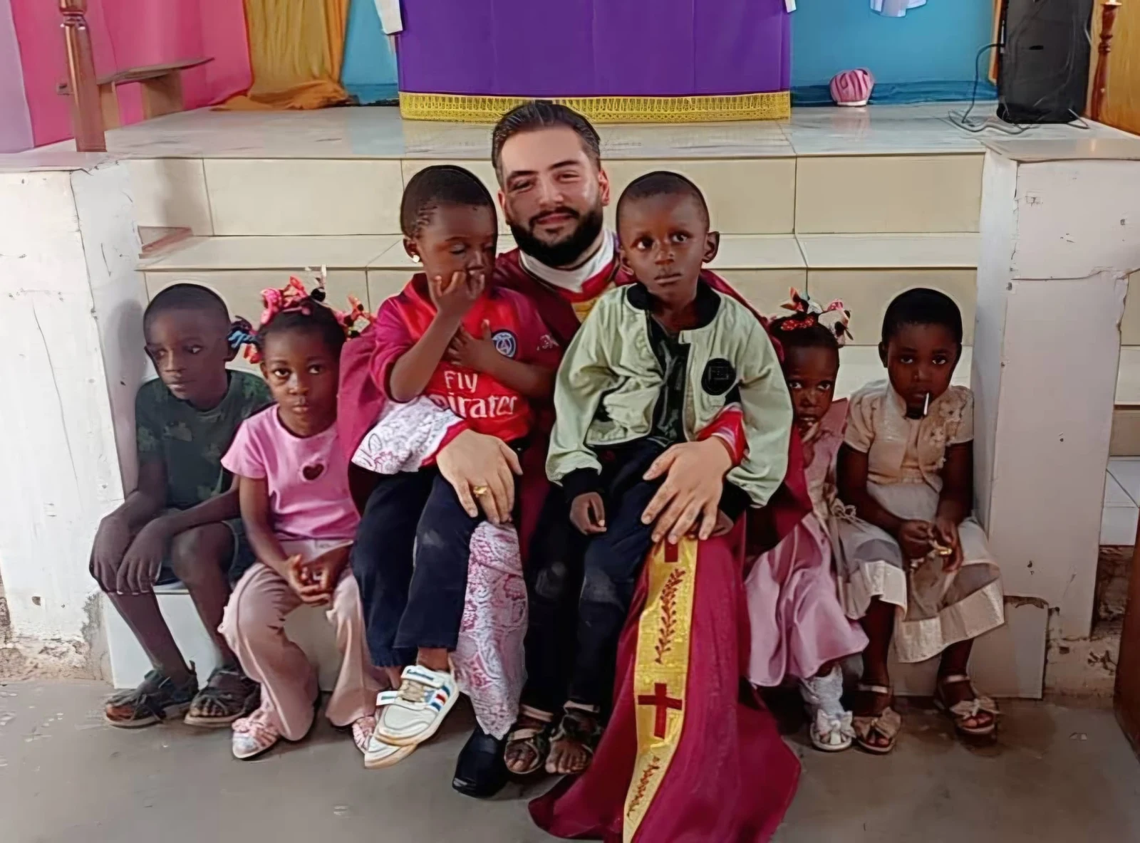 A missionary with children in the mission chapel.